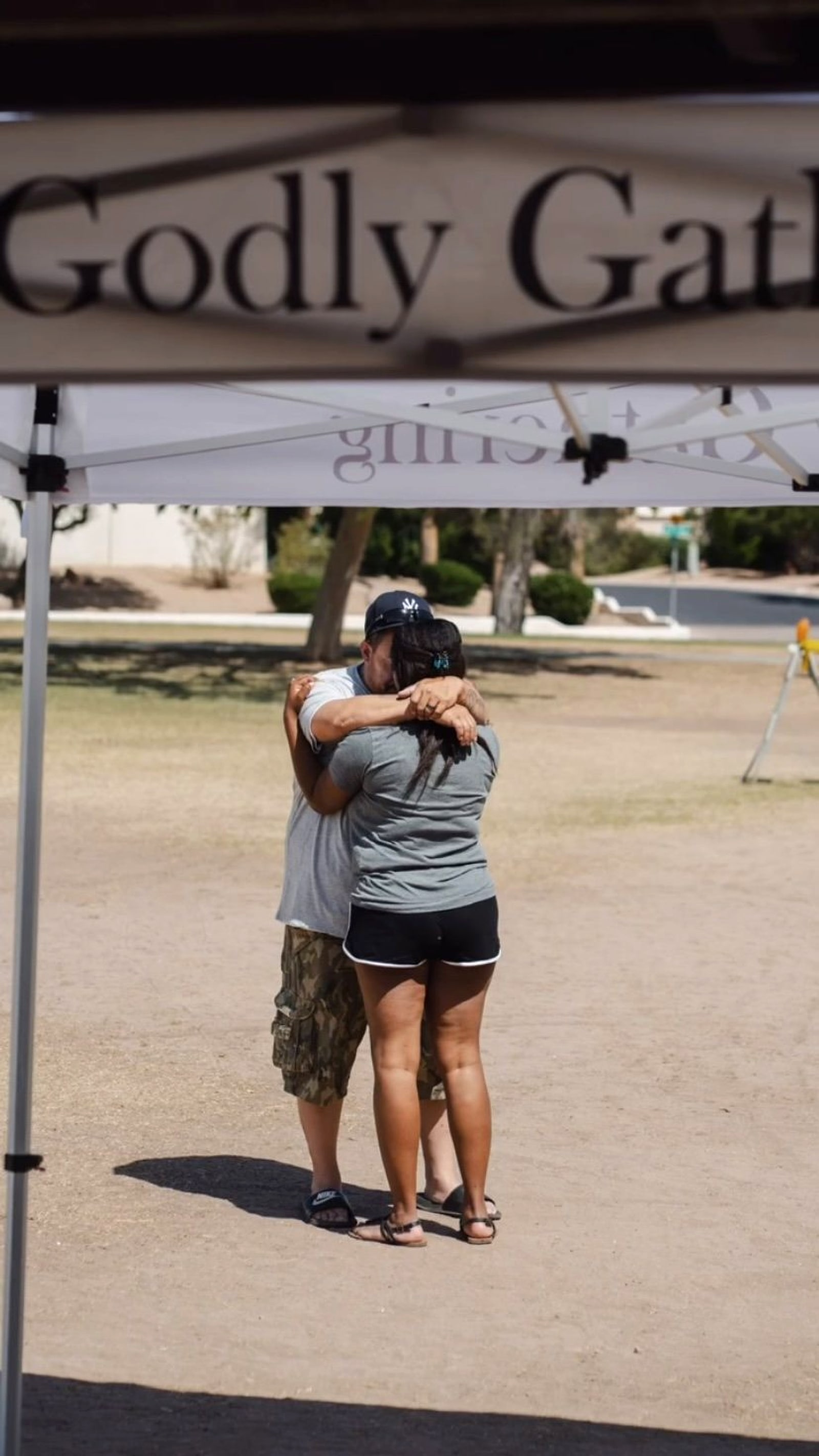 Two people hugging under the canopy