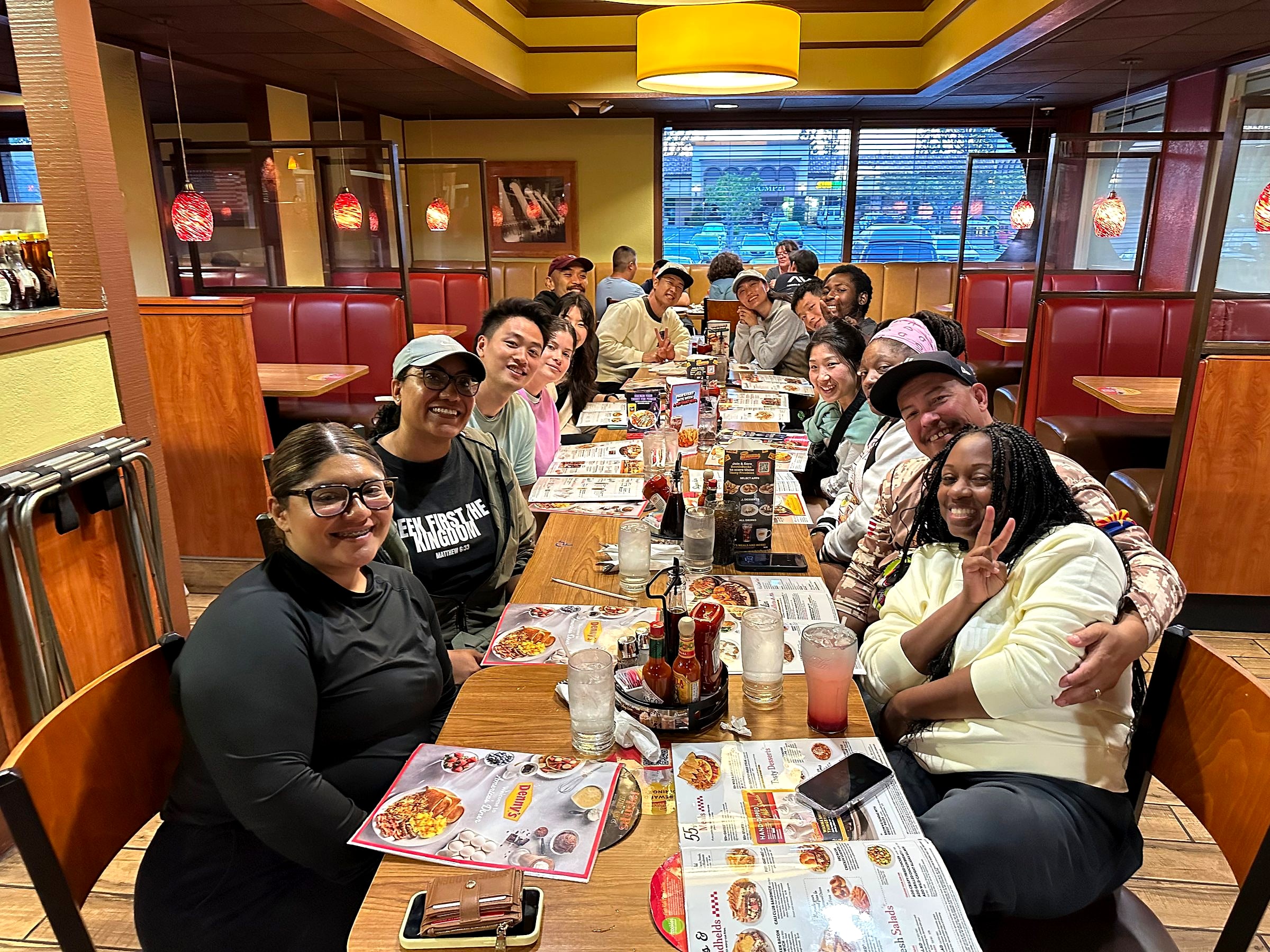 The group sharing a meal around a long table