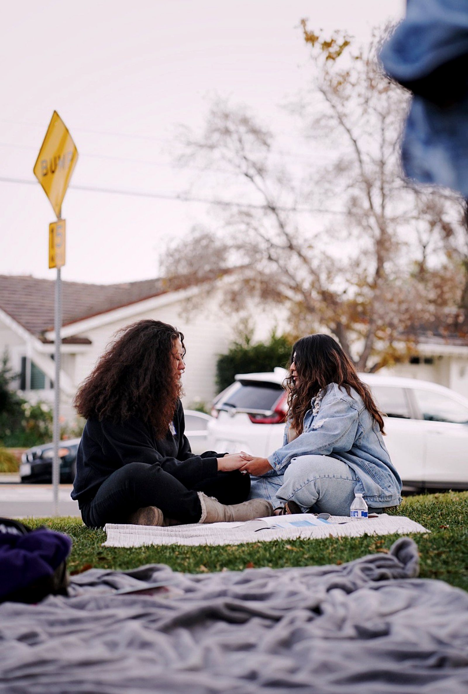 Two women talking on a blanket